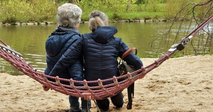 Garlic may help prevent Alzheimer's disease and Dementia - Two old ladies sitting on a swing