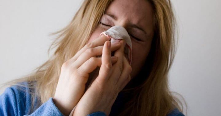 Home remedy for the common cold - Image of a lady with cold.